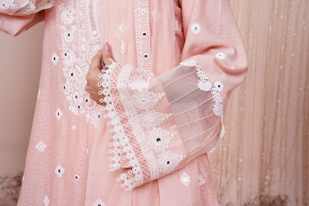 a close up of a person wearing a pink dress