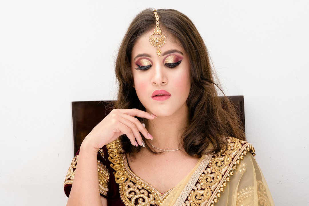 sitting woman wearing black and gold sari dress