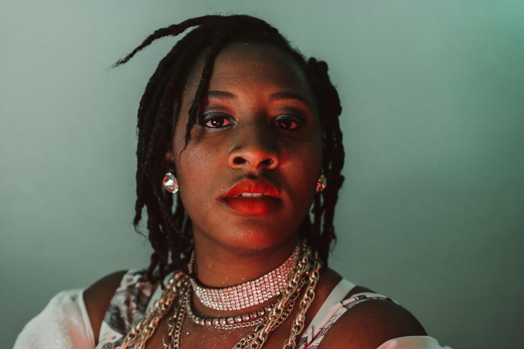 Woman with dreadlocks wearing layered necklaces
